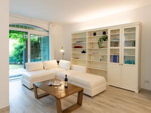 a living room with a white couch and a table at Holiday Home Luxury House by Interhome in Colico
