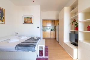 1 dormitorio pequeño con 1 cama y cocina en Bright Studio with terrace & parking, en Bari