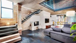 a living room with a staircase and a brick wall at Villa Baraka in Kanfanar