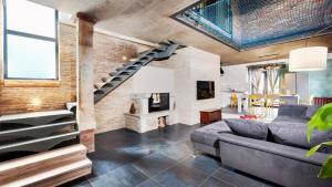 a living room with a staircase and a brick wall at Villa Baraka by Villas Holiday in Kanfanar