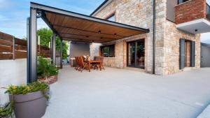 an outdoor patio with a wooden pergola at Villa Baraka by Villas Holiday in Kanfanar