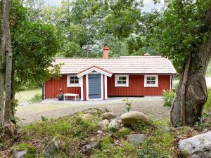 a red cottage with a bench in front of it at Chalet Jennys by Interhome in JÃ¤mjÃ¶