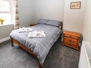 a bedroom with a bed with two towels on it at Kilderkin in Bedale