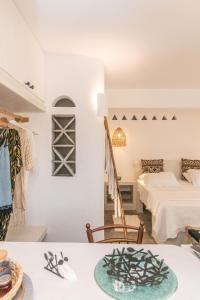 a room with a bed and a bed and a room with a table at Saffron Boutique in Krokos
