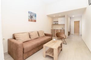 a living room with a couch and a table at Apartments Ada Bojana in Ulcinj