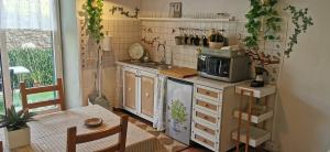 a small kitchen with a sink and a microwave at La Maison de Jardin in Lucca