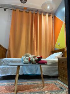 a bed room with a table with stuffed animals on it at Appartement familiale Amjad 3 chambres in Tangier