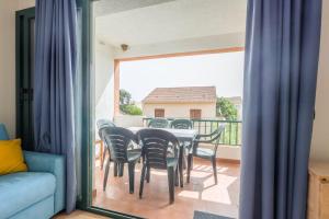 a dining room with a table and chairs on a balcony at La Casa de Franck in Linguizzetta +3 photos