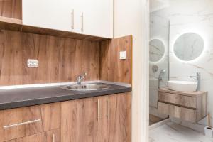 a bathroom with a sink and a shower at Apartments Ada Bojana in Ulcinj