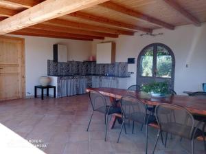 a dining room with a wooden table and chairs at Villa Jewels 2 in Gaggi
