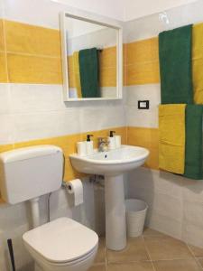 a bathroom with a white toilet and a sink at Villa Jewels 2 in Gaggi +21 photos