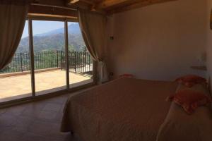 a bedroom with a bed and a large window at Villa Jewels 2 in Gaggi