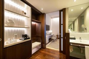 a bathroom with a sink and a toilet at Hospes Amérigo, Alicante, a Member of Design Hotels in Alicante