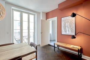 a dining room with a table and a bench at Stylish 4 Bedroom flat in CPH City in Copenhagen