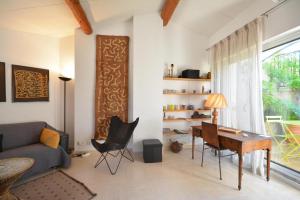 a living room with a table and a couch at Terrasses du château in Le Barroux