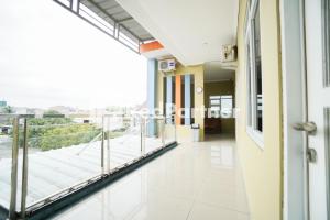 a corridor of a building with a balcony at Indah Residence Syariah Mitra RedDoorz in Jakarta