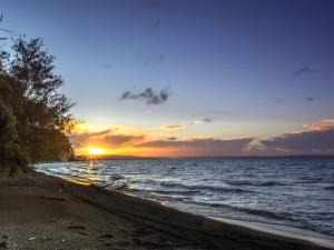 um pôr-do-sol numa praia com o oceano em Bordemundo B&B y Cabañas em Puerto Varas