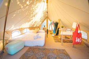 a bedroom with a bed in a tent at Kampaoh Flumendosa in Santa Margherita di Pula