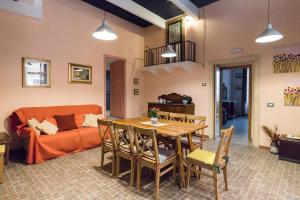 a living room with a table and a couch at Al Palazzetto di Milo in Milo