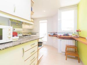 a kitchen with white cabinets and a counter top at Apartment Villas del Mar by Interhome in Jávea