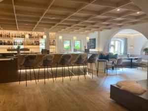 a bar with chairs and a counter in a room at Aparthotel Weinklause Superior in Oberstdorf