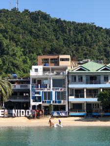 a group of people playing on the beach at The Beach House in El Nido