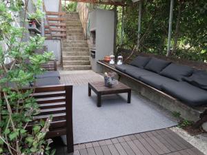 a couch and a coffee table on a patio at Apartment Branka by Interhome in Mošćenička Draga