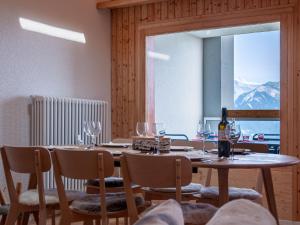 a dining room with a table with wine glasses at Apartment Haut de Cry 16 by Interhome in Nendaz