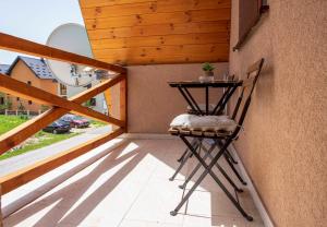 einen kleinen Balkon mit einem Tisch und einem Stuhl in der Unterkunft Casa Del Durmitor in Žabljak