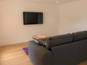 a living room with a couch and a table at Apartment Wiedersehn 1- Stock by Interhome in Grächen