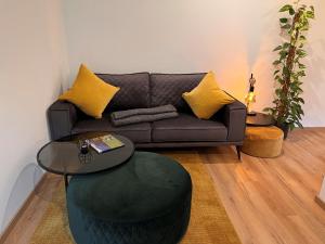 a living room with a couch and a table at Apartment Apartement Haus Dankl by Interhome in Fusch an der Glocknerstraße