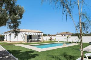a house with a swimming pool in a yard at Marta's Paradise in Conil de la Frontera