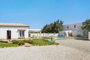 a house with a yard and a swimming pool at Marta's Paradise in Conil de la Frontera