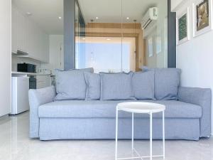 a blue couch in a living room with a table at Phaedrus Living: Marina Sea View Flat 214 Emerald in Paphos