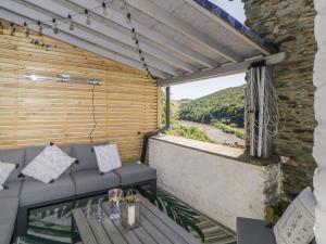 a balcony with a bench and a view of a river at Secret Lookout in Calstock