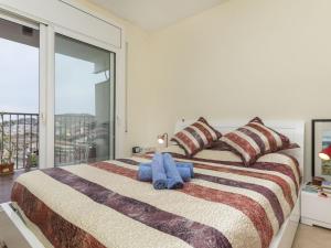 a bedroom with a large bed with a large window at Apartment Sa Coma by Interhome in Tossa de Mar