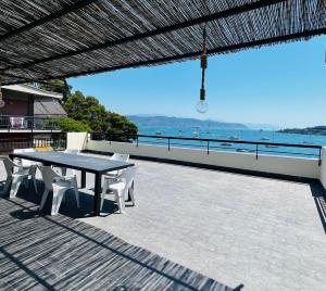 a table and chairs on a patio with a view of the ocean at La Grande Terrazza in Portovenere
