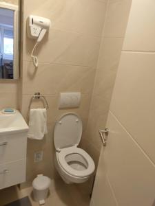 a small bathroom with a toilet and a sink at Apartments Miličević in Gradac