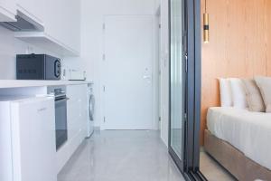 a small kitchen with a bed and a microwave at Phaedrus Living: Marina Sea View Flat 214 Emerald in Paphos