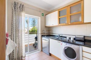 a kitchen with a sink and a dishwasher at Quinta Gomeira 69 in Cabanas de Tavira
