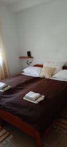 a bedroom with a large bed with towels on it at Apartments Miličević in Gradac