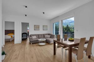 a living room with a couch and a table at Dei apartment in Makarska +2 photos