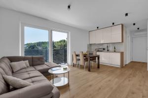 a living room with a couch and a table at Dei apartment in Makarska
