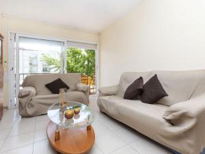 a living room with two couches and a coffee table at Apartment Puig Sapera by Interhome in Sant Antoni de Calonge +13 photos