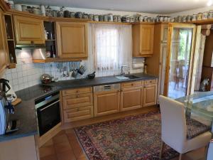 a kitchen with wooden cabinets and a counter top at Holiday Home Chalet Bergnest by Interhome in Pragg-Jenaz