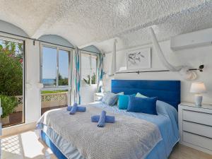 - une chambre dotée d'un lit bleu avec des oreillers bleus dans l'établissement Holiday Home Bahía Dorada Playa by Interhome, à Estepona