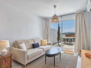 a living room with a couch and a table at Apartment Doña Julia Golf Views by Interhome in Bahia de Casares