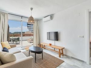 a living room with a couch and a tv at Apartment Doña Julia Golf Views by Interhome in Bahia de Casares