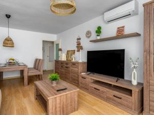 a living room with a large television and a table at Apartment Atria-3 by Interhome in Torremolinos