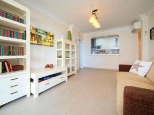a living room with a couch and book shelves at Apartment Etxezuri by Interhome in Calpe